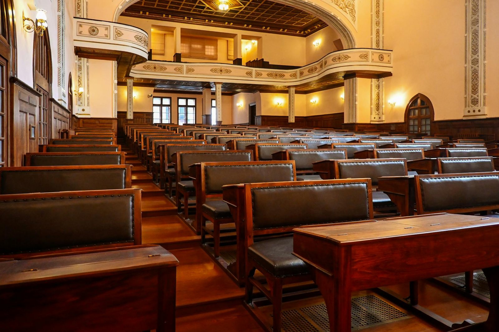 Historic lecture hall with wooden benches representing classical education programmes