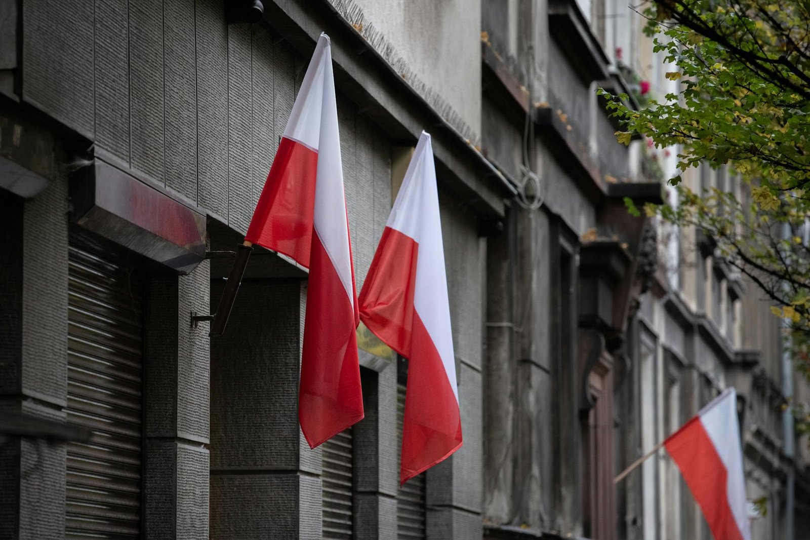 Polish flags on a historic building representing national heritage
